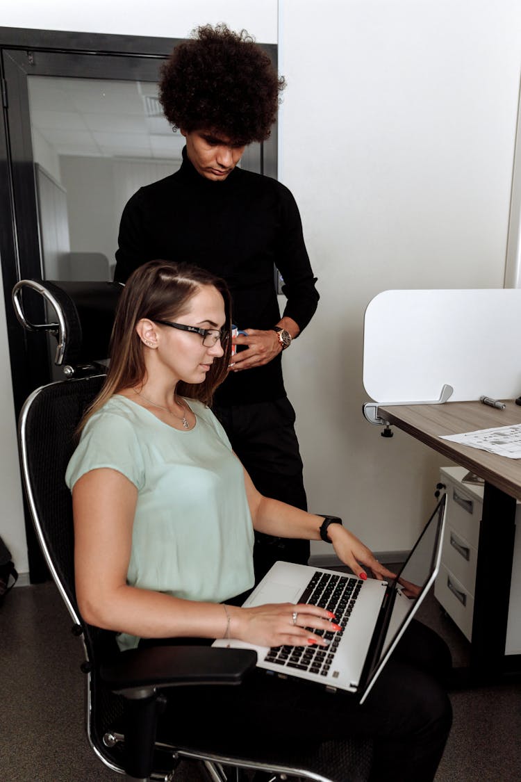 Man And Woman Looking At The Laptop