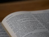 White Book Page on Brown Wooden Table