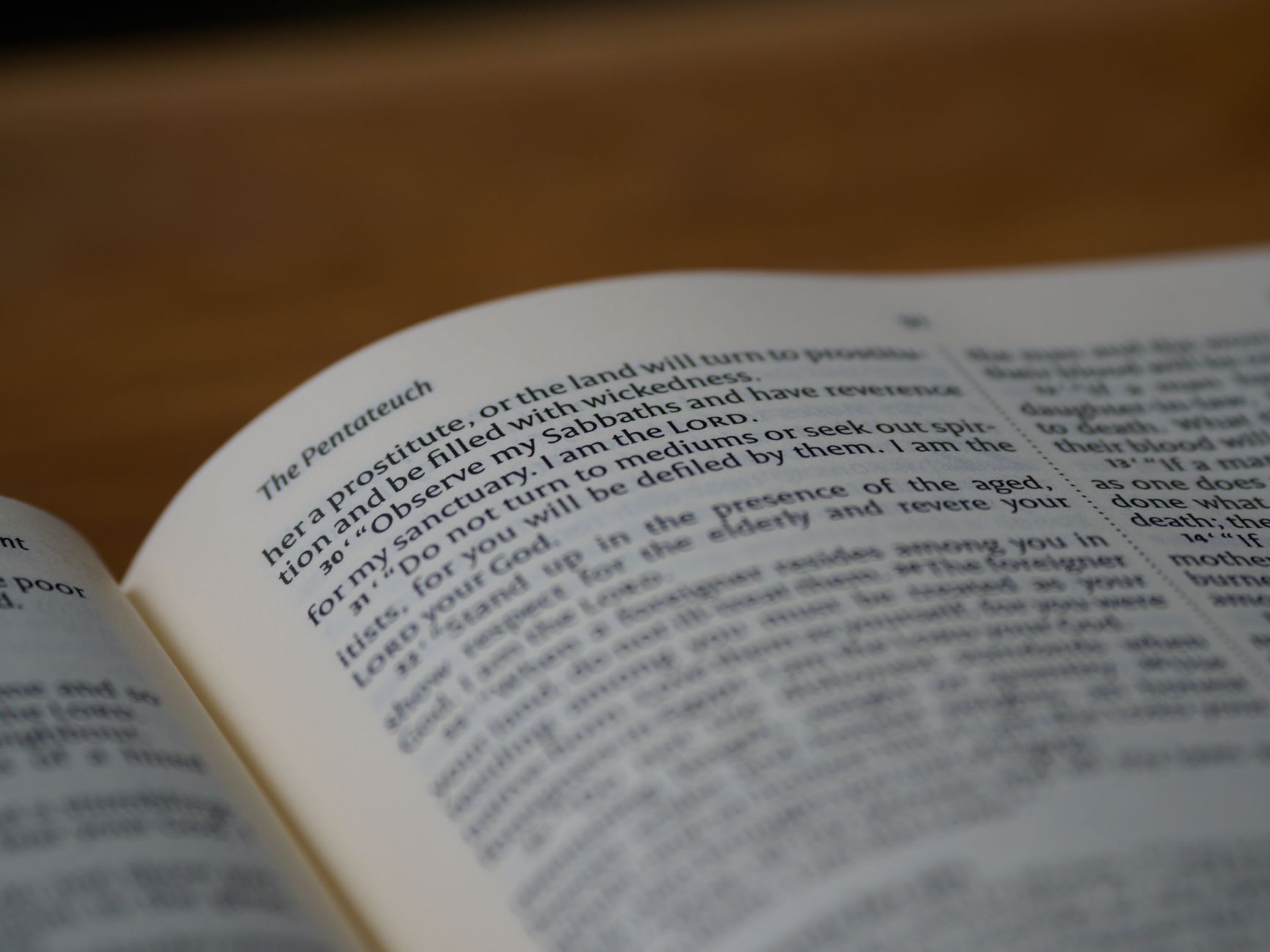 Detailed close-up of the Pentateuch page in an open Bible, highlighting the text and symbolism.
