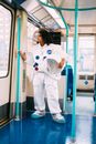 在城市火车上，一位穿着宇航员服的女人将太空主题与公共交通融为一体