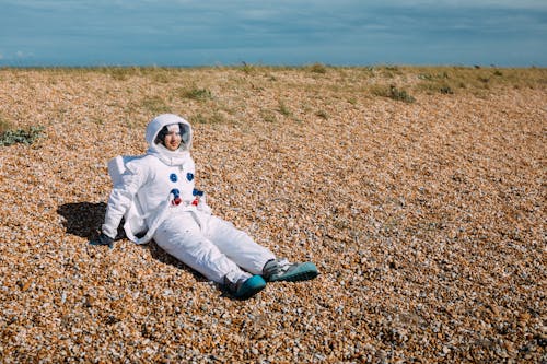 Person Wearing A Space Suit In The Middle Of A Desert