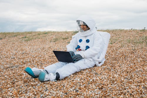 Man In A Space Suit Using Laptop