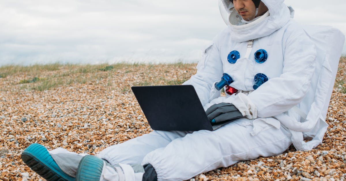 Astronaut Using a Laptop · Free Stock Photo