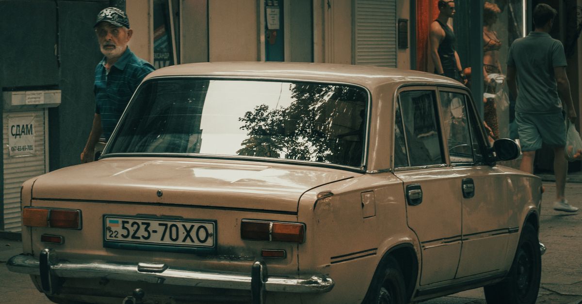 Rear of a Classic Car Parked on the Sidewalk · Free Stock Photo