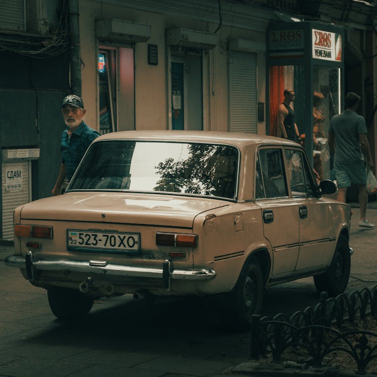 Rear Of A Classic Car Parked On The Sidewalk