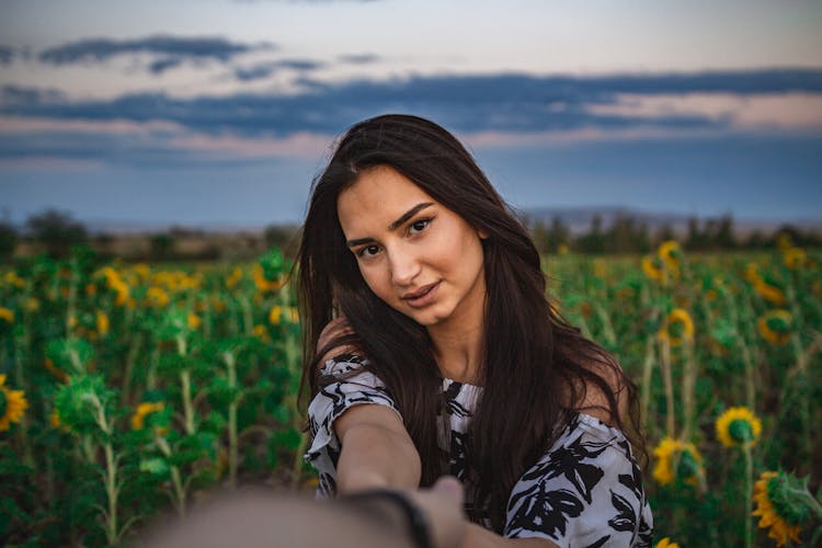 A Woman Doing Selfie In The Sunflower Field