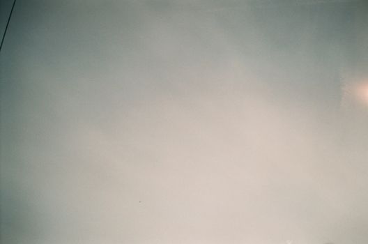 A serene view of a clear sky with soft clouds, perfect for background or design work.