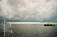White Boat on Sea Under White Clouds