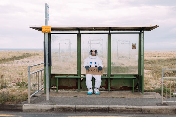 Astronaut Waiting At A Bus Stop