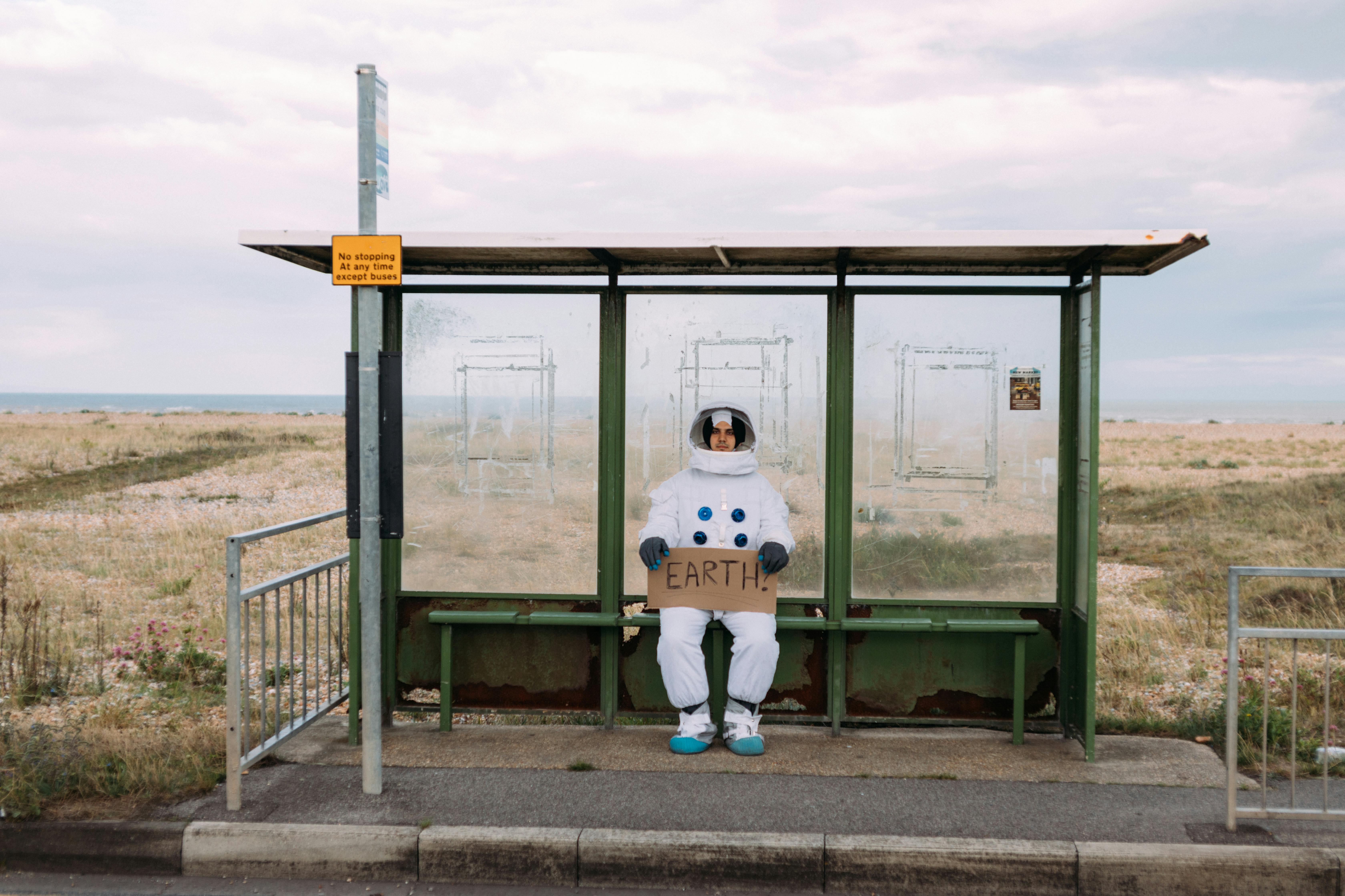 astronaut waiting at a bus stop