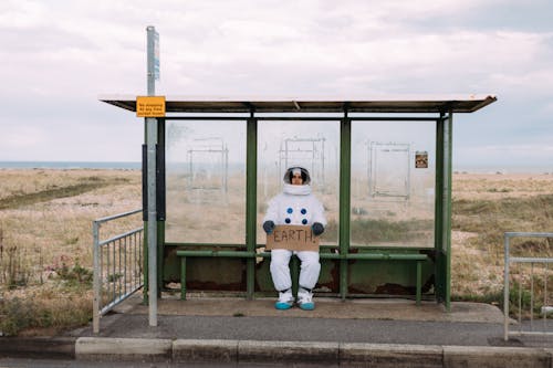 Free Astronaut Waiting At A Bus Stop Stock Photo