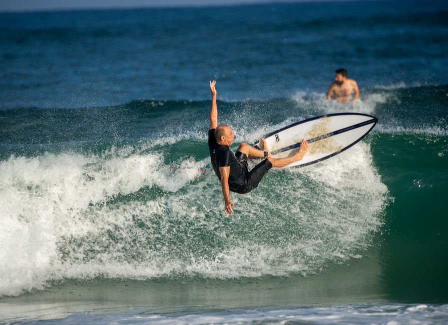 A thrilling capture of a surfer executing a skillful maneuver on a powerful ocean wave.