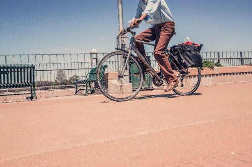 Man Riding Commuter Bike Near Road in Close-up Photography