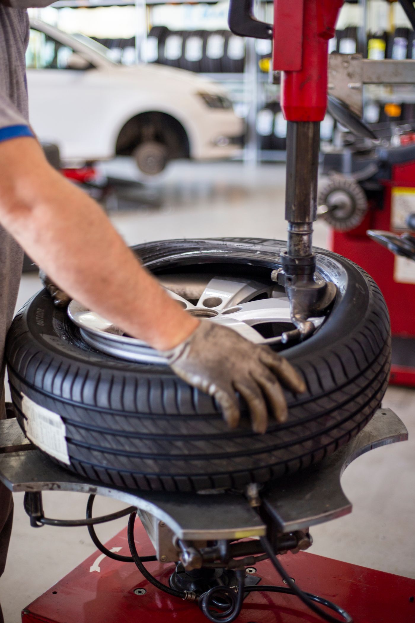 Tire being mounted on a wheel using workshop equipment
