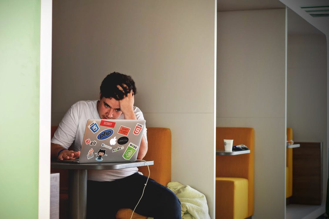 Man looking at his Macbook Pro with Worry