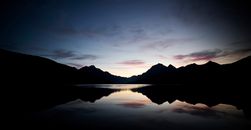 Tranquil View of Mountain Range Reflecting in Lake after Sunset