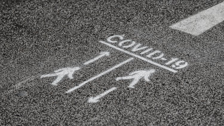 Social Distance Sign On Asphalt Road