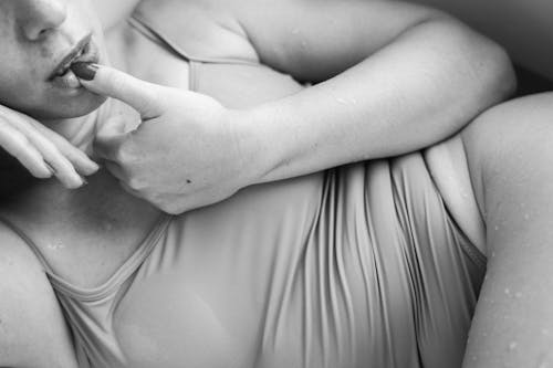 Grayscale Photo of Woman Touching her Lip