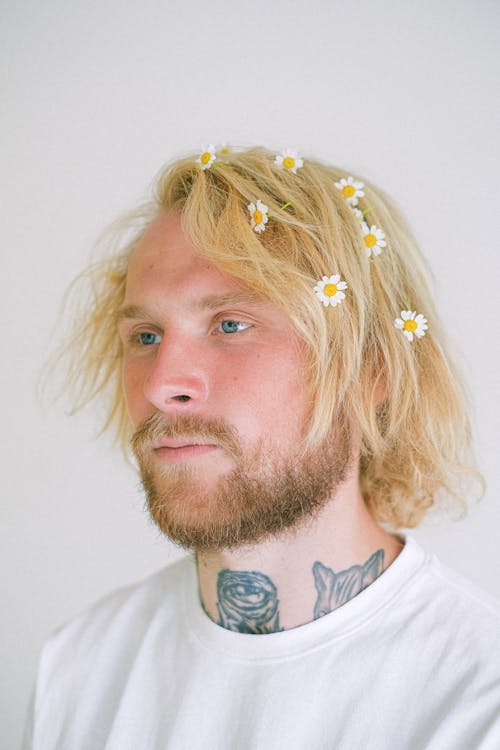 Young man with flowers on head