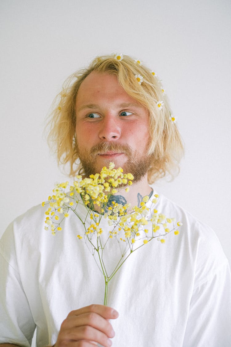 Blond Man With Yellow Flowers In Hand