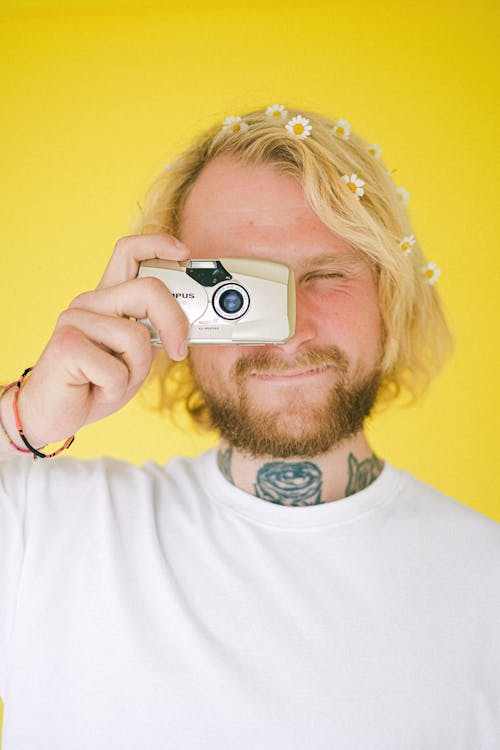 Young man taking photo with camera