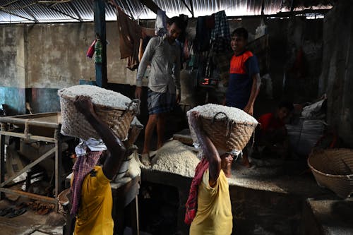 People in a Market Carrying Woven Baskets