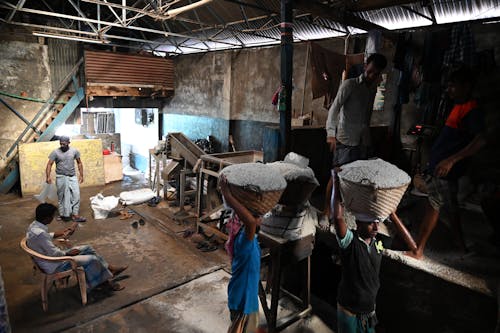 Men Carrying Baskets of White Powder on Their Heads