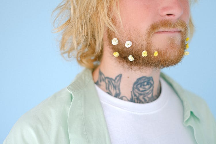 Crop Tattooed Man With Flowers On Red Beard