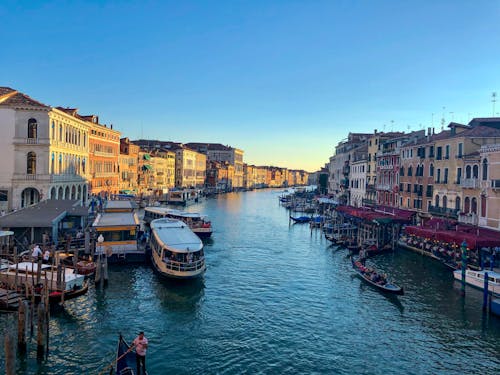 Boats on River Between Buildings