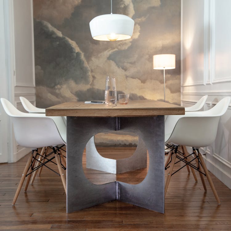 A Wooden Dining Table With Armchairs