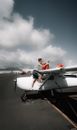 Man pouring petrol in propeller aircraft fuel tank