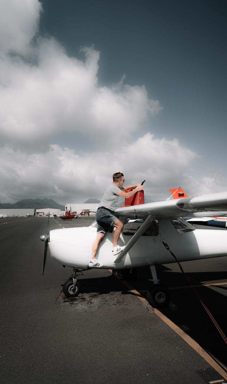 Man Pouring Petrol In Propeller Aircraft Fuel Tank