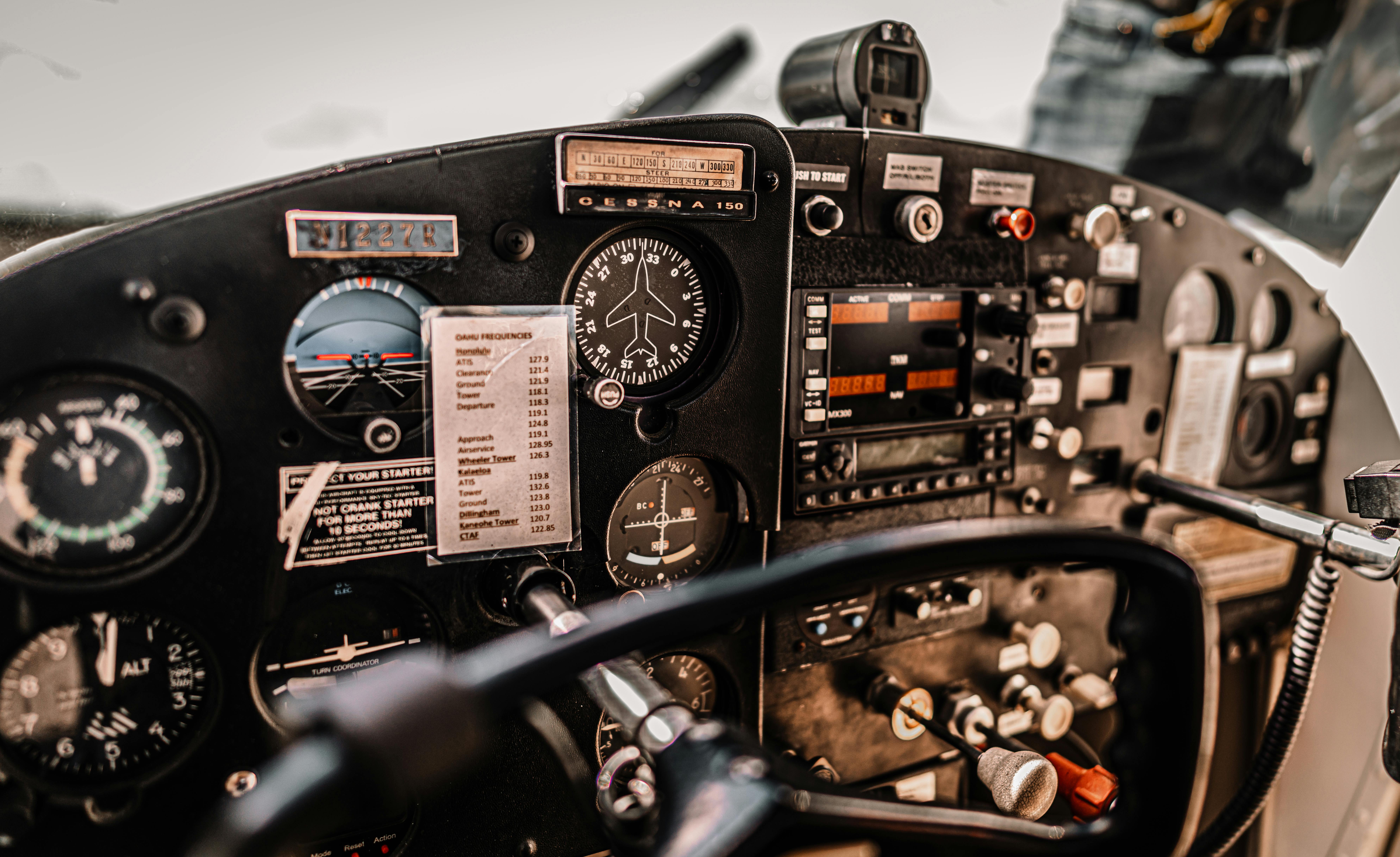 Close-up of cockpit instruments in a Cessna 150 light aircraft, showcasing avionics and controls.