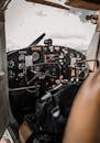Control panel and yokes of modern light aircraft parked on aerodrome under cloudy sky