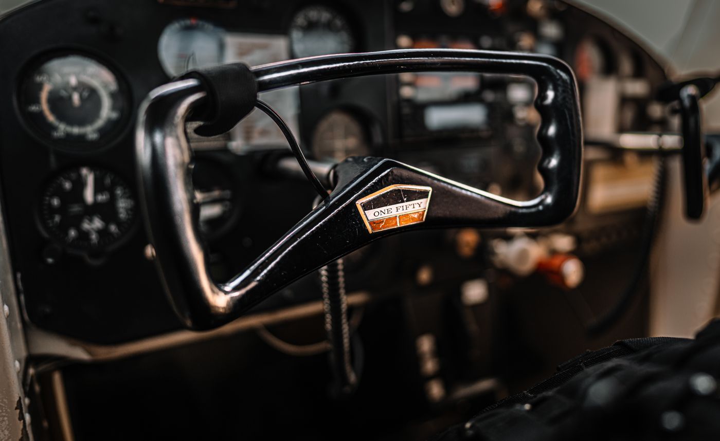 Closeup of steering wheel and instrument panel in cockpit of retro basic trainer aircraft