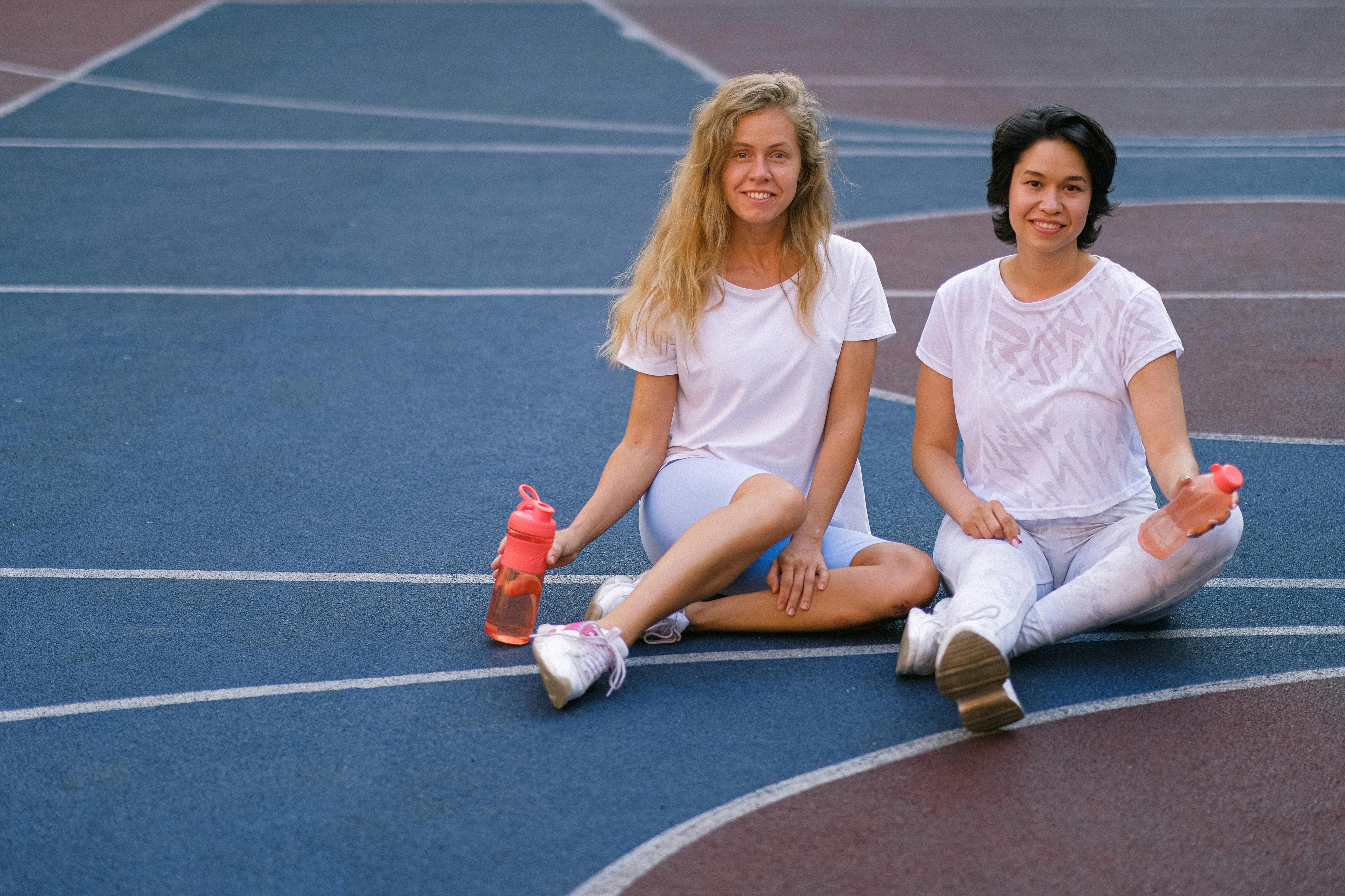 Ladies warming up on bench in yard · Free Stock Photo