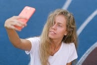 Lady using smartphone for photo on court