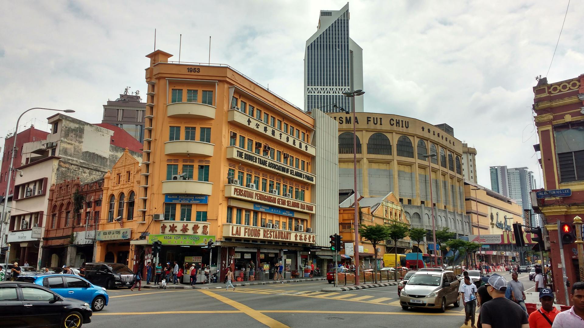 Vibrant street view of Kuala Lumpur's Central Market with pedestrians and urban architecture.