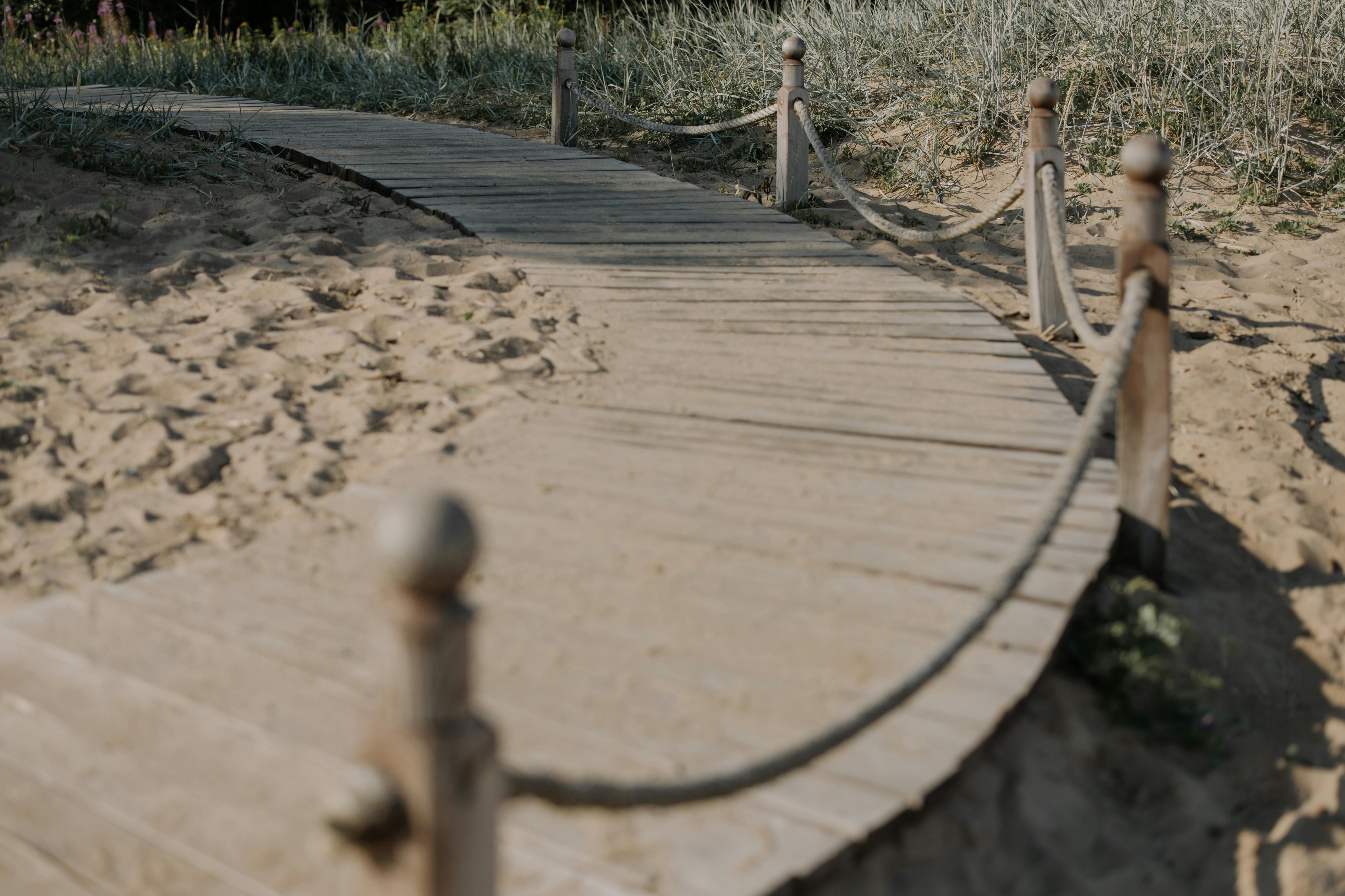 Wooden Bridge Over Brown Sand · Free Stock Photo