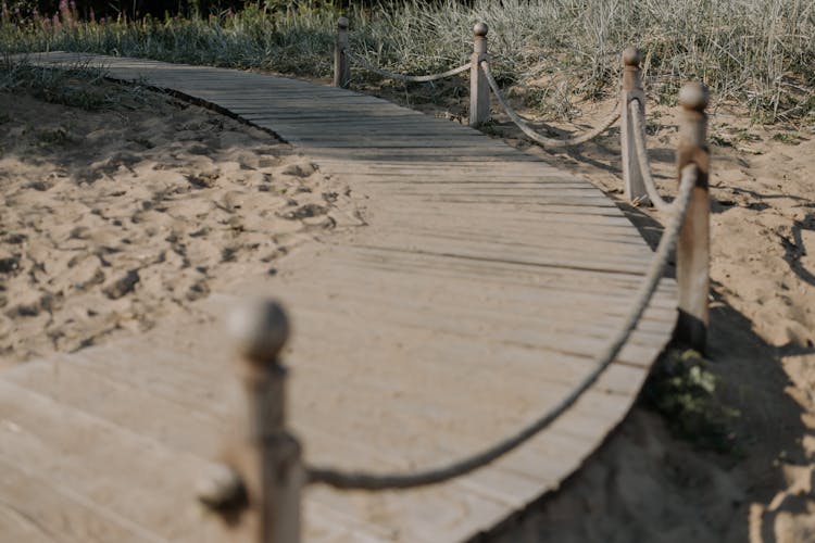 Wooden Bridge Over Brown Sand