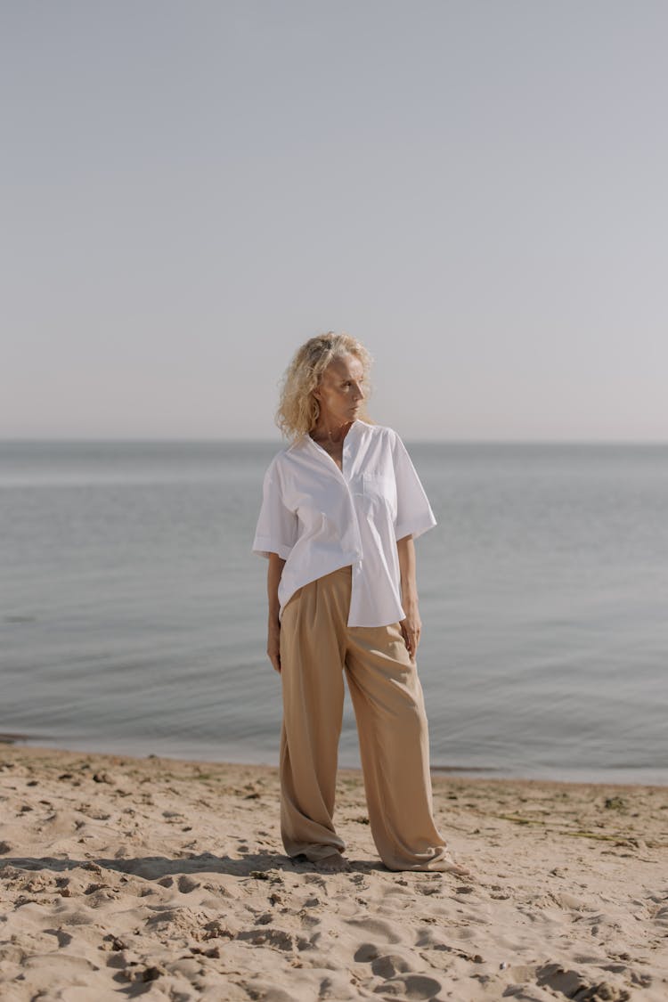 Elderly Woman Standing On Shore