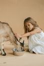 Girl in White Dress Lying on Bed With Brown Animal