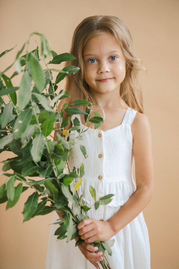 A Girl Holding A Plant