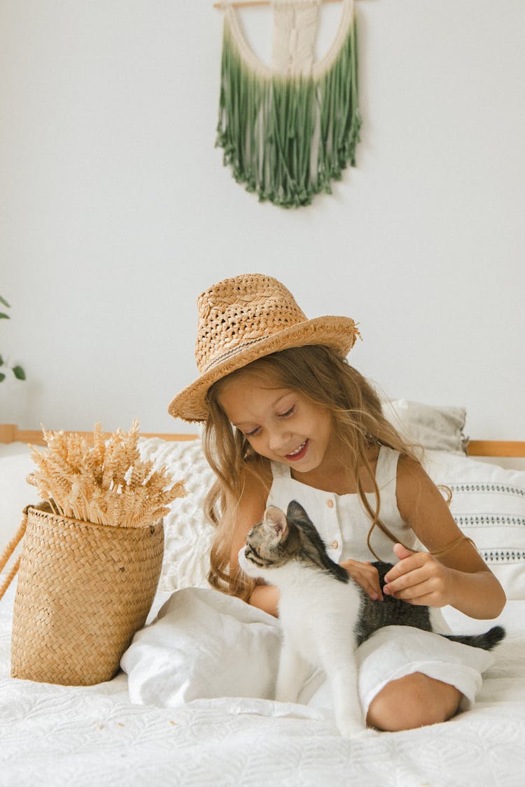 Girl In Hat Sitting With Cat