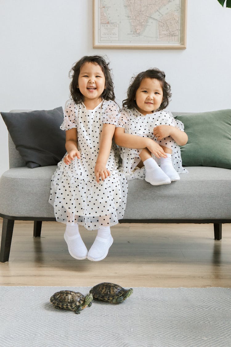 Smiling Girls Posing At Home With Turtles