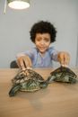 Boy in Blue Dress Shirt Holding Turtle