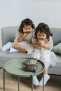 Happy Little Girls Playing with Turtles at Home