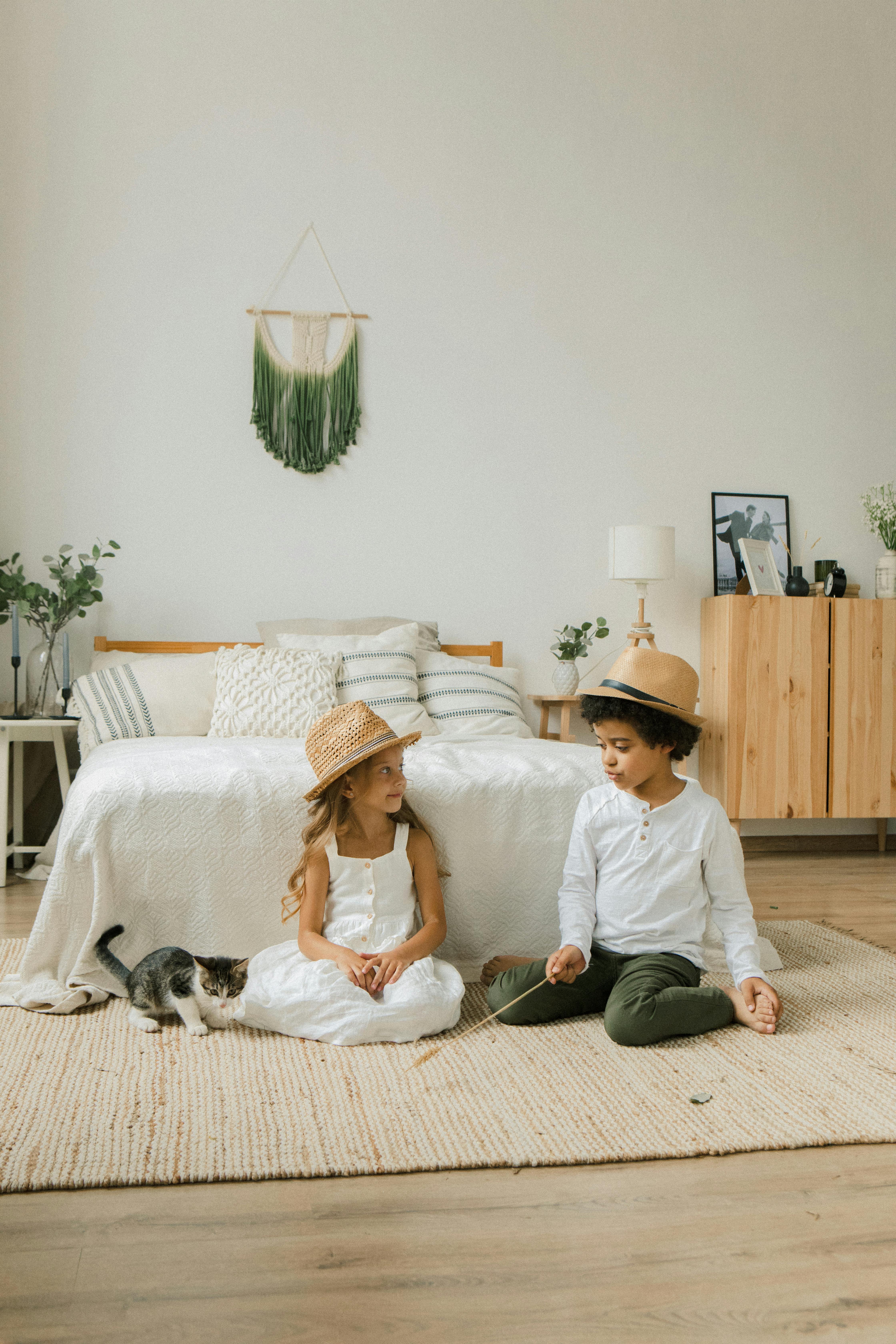 children playing with cat at home