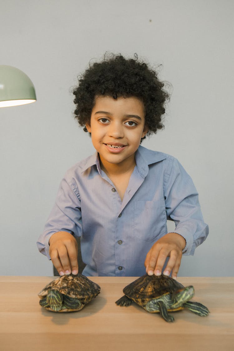 Portrait Of A Boy With Pet Tortoises