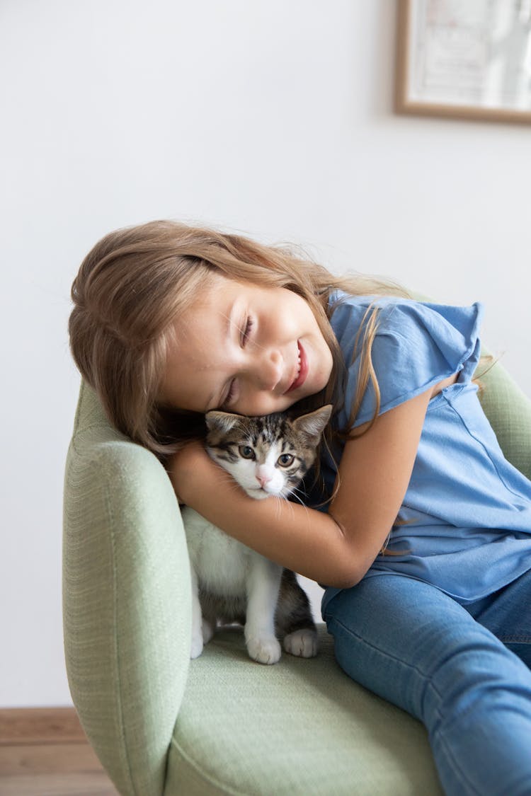 Happy Girl Hugging Kitten